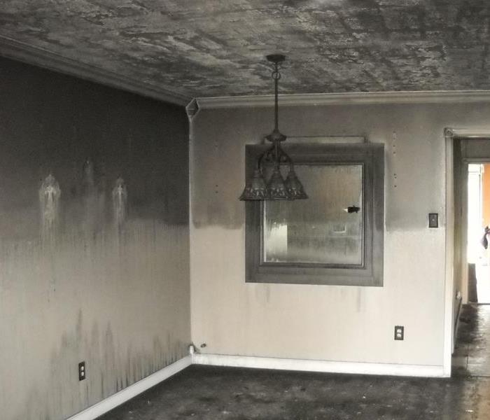 Soot covering the walls and the ceiling in a room.